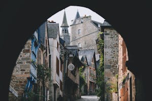 Explore the picturesque medieval streets of Dinan, France with this charming alley view.